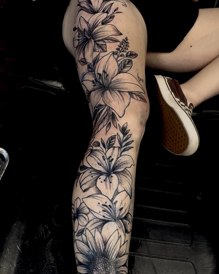 Black-and-grey floral leg piece - lilies and a sunflower down the leg.