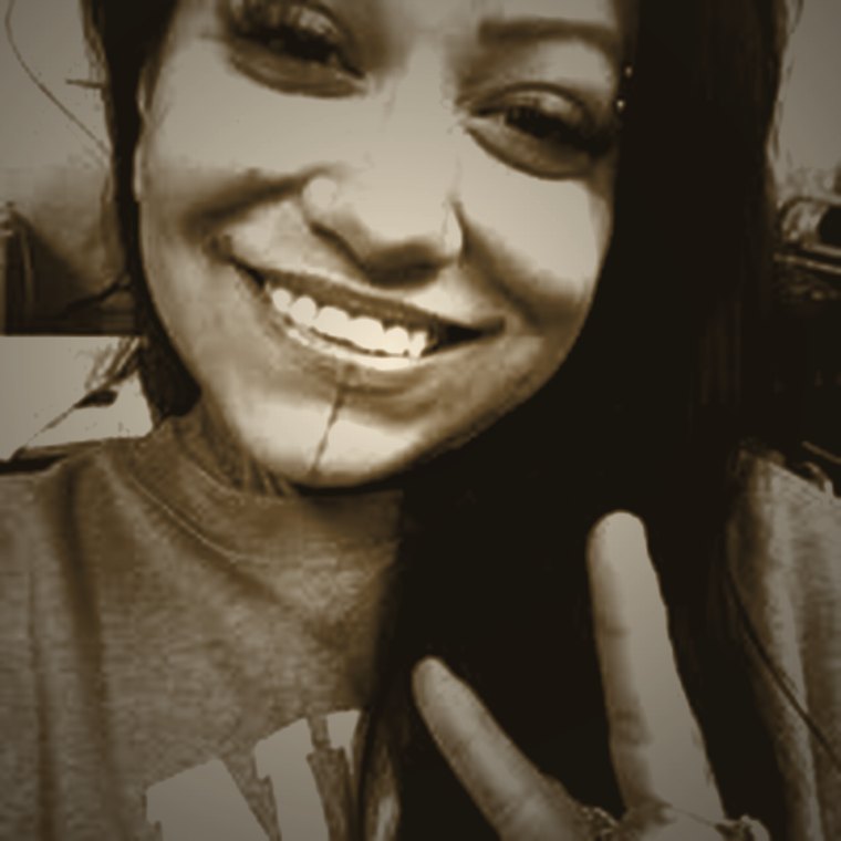 Ariel DeJesus, tattoo artist and owner of Blindfold Tattoos, smiling.